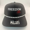 Black cap with 'FREEDOM' text and a signature on a white background