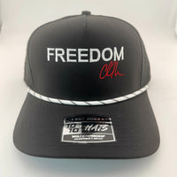Black cap with 'FREEDOM' text and a signature on a white background