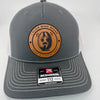 Richardson 112 trucker hat with custom laser engraved leather patch featuring I Flick More Bean Than a Coffee Shop logo, Charcoal and White color scheme