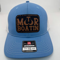 Richardson 112 trucker hat with custom laser engraved leather patch featuring Motor Boatin logo, Columbia Blue and white color scheme