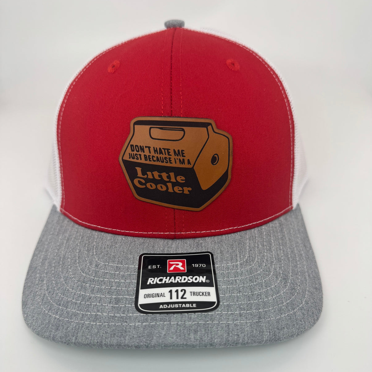 Richardson 112 trucker hat with custom laser engraved leather patch featuring Don't Hate Me Just Because I'm A Little Cooler logo, Red, White, and Heather Grey scheme