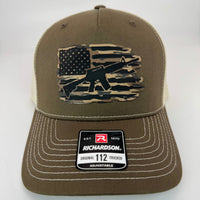 Richardson 112FP trucker hat featuring a patch with a USA flag and M16 rifle in the center, classic mesh back and adjustable snapback closure.