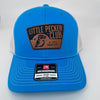 Cyan and white Richardson 112 trucker hat with a “Little Pecker Club” patch on the front.