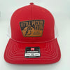 Red and white Richardson 112 trucker hat with a “Little Pecker Club” patch on the front.