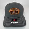 Richardson 112 patch hat in charcoal with white mesh, featuring a laser-engraved leather patch reading "Hoochie Daddy" on the front panel.