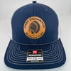Navy Richardson 112 hat with white mesh back, featuring a laser-engraved leather patch that reads “Chief Kickabitch from the Slapahoe Tribe.”