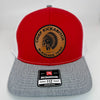 Red Richardson 112 hat with white mesh back and heather grey accents, featuring a laser-engraved leather patch that reads “Chief Kickabitch from the Slapahoe Tribe.”
