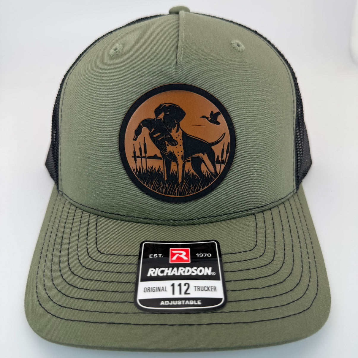 Richardson 112FP trucker hat with custom laser engraved leather patch featuring BirdDog logo, Loden Green and Black Mesh Color scheme