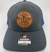 Richardson 112 trucker hat with custom laser engraved leather patch featuring Overtime Hours, Working All Day For Bullshit Pay logo, Charcoal and Neon Blue color scheme